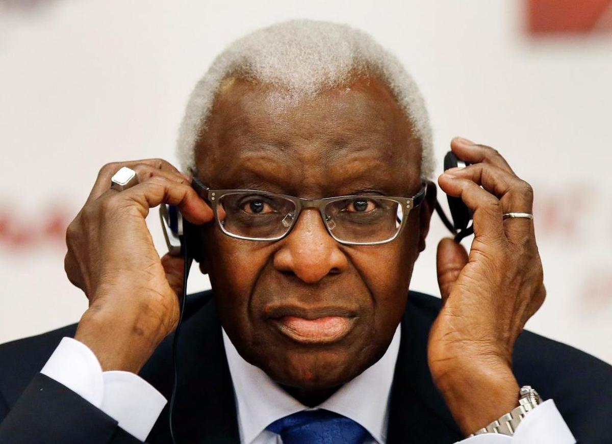 Then-IAAF president Lamine Diack adjusts his headphones during a joint IOC and IAAF news conference in Beijing in 2015. Diack is now in French custody and has been accused of receiving bribes while he was on the committee that voted for Rio as the 2016 Olympics host city.