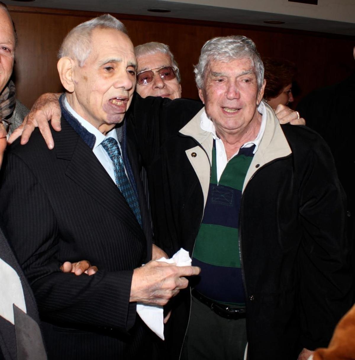 Perhaps their generation’s most militant anti-Castro exiles stand arm in arm at a 2009 event in Miami celebrating the release of Orlando Bosch’s memoirs. Bosch, left, is greeted by Luis Posada Carriles, right.