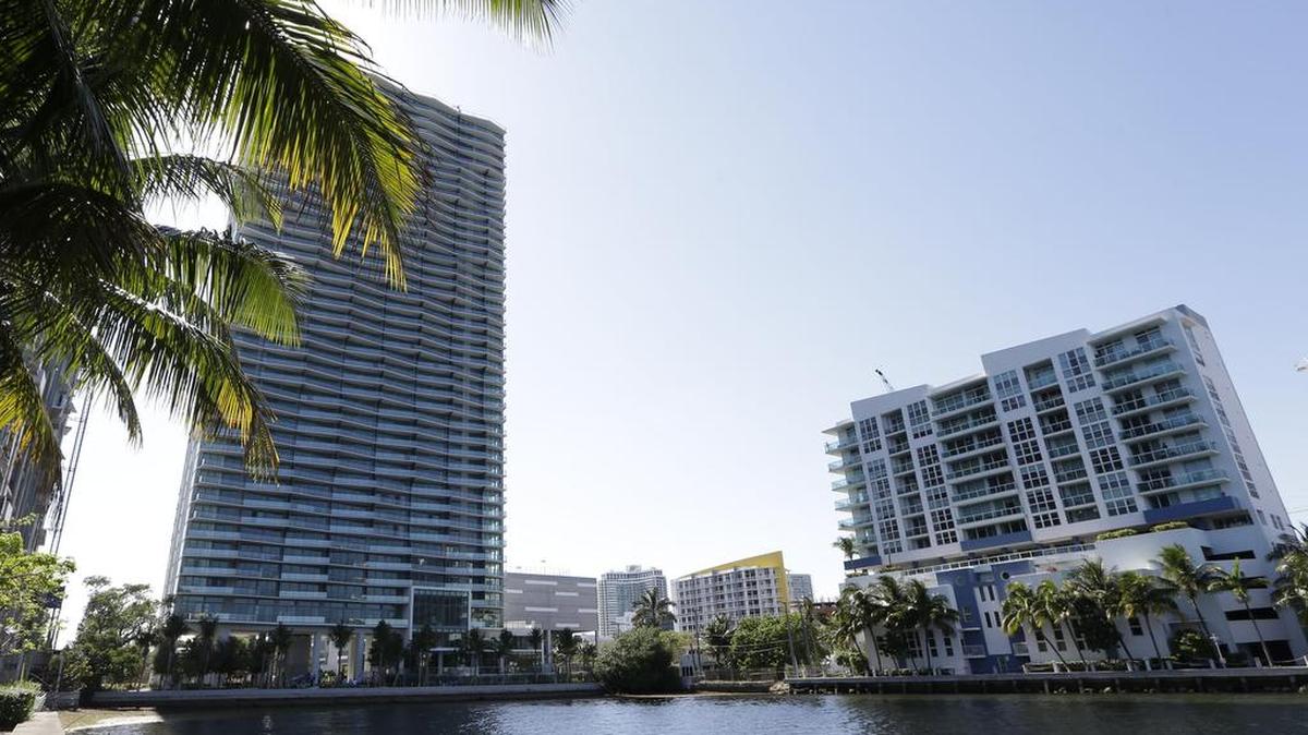 In this May 20, 2015, photo, a luxury high-rise condominium, left, is in the final phase of construction in Miami. Those who live in the higher floors of a high-rise building will feel the building swaying more in a storm than those who live on the bottom floors.