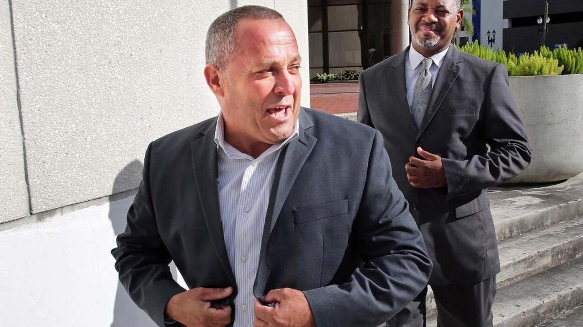 Luis Santiago, former commissioner for the city of Opa-Locka, exits the federal courthouse in Miami after surrendering to bribery charges in late 2016 with his defense attorney Roderick Vereen.