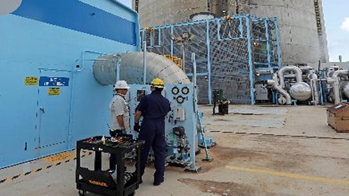 Pehter Rodriguez and Juan Madruga, both instrument & control specialists work on the nuclear reactor unit 4 turbine Thursday, May 18, 2017 at Turkey Point.