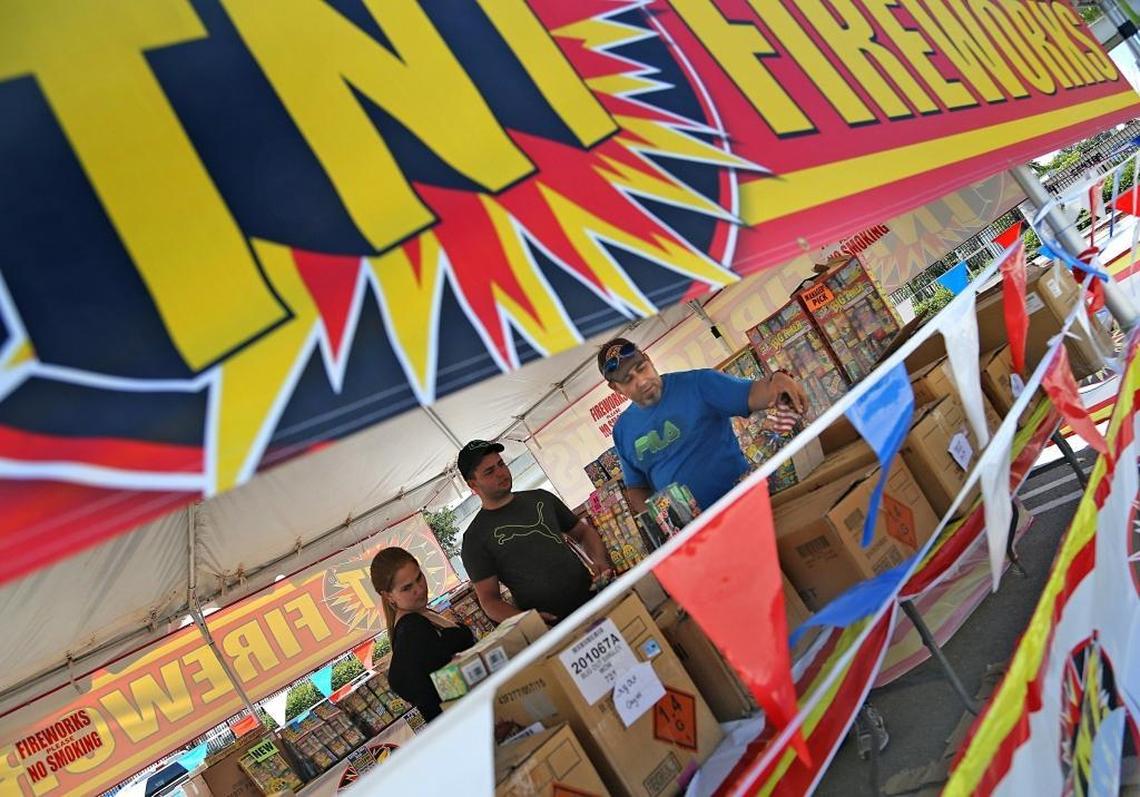 Armando Noche, 47, right, operates “TNT Fireworks” with help from his sons. They’re helping customers buy fireworks for the July Fourth celebration, July 3, 2017.