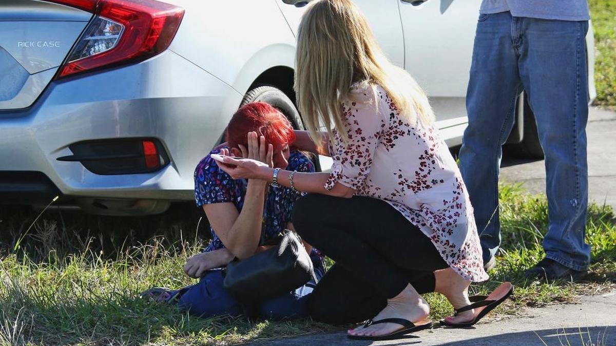 A woman consoles another as parents wait for news regarding a shooting at Marjory Stoneman Douglas High School in Parkland, Fla., Wednesday, Feb. 14, 2018. A shooter opened fire at the Florida high school Wednesday, killing people, sending students running out into the streets and SWAT team members swarming in before authorities took the shooter into custody.