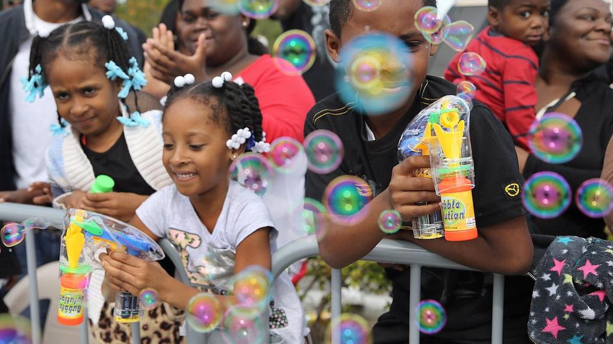 Children blow bubbles on the parade route. On Monday January 18, 2016, the annual Martin Luther King, Jr. parade was held in the Liberty City in honor of the apostle of non-violence and civil rights.