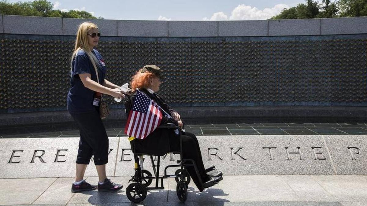 Marine Corps/Air Corps veteran Conni Gordon, of Miami, is accompanied through the National World War II Memorial in May 2015 as part of an Honor Flight.