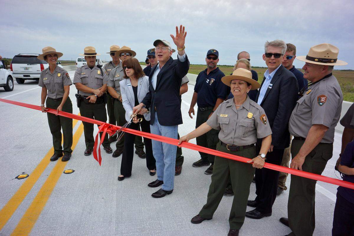 LONG-AWAITED MOMENT: U.S. Secretary of the Interior Ken Salazar on Tuesday prepares to cut the ribbon to dedicate the new Tamiami Trail Bridge, which will allow water to flow under it.