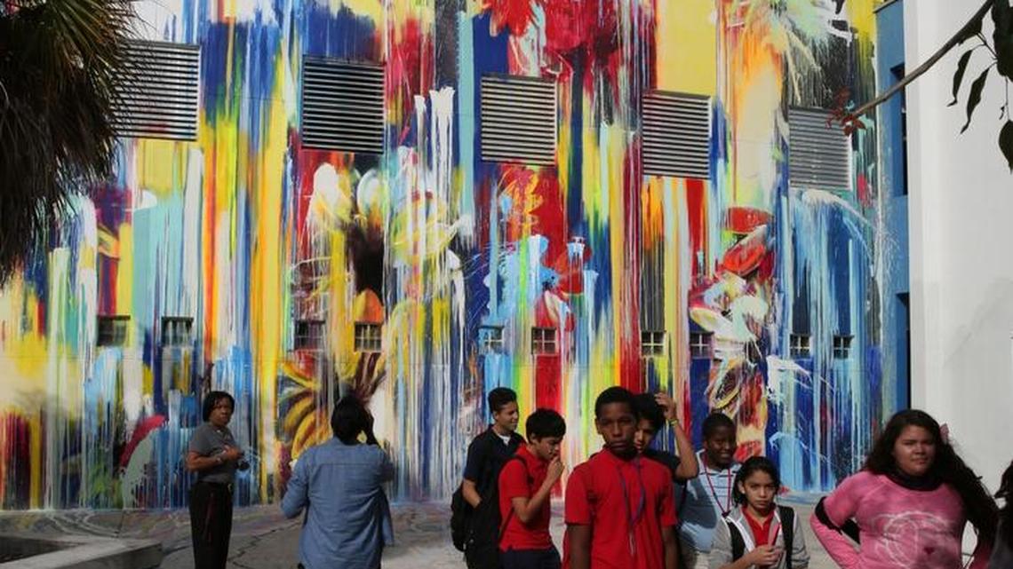 Students walk through the courtyard area of Jose de Diego Middle to study the murals painted by artists who donated their time to help revitalize the Wynwood school.