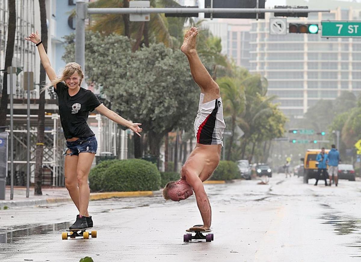 Skaters Martina, a tourist from Holland, and Adam Todd, of England, who lives in South Beach, ride along an almost deserted Ocean Drive as Hurricane Irma approached South Florida on September 09, 2017.