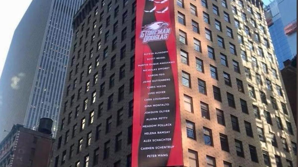 Three signs adorn a Times Square building atop the SuperDry Store on March 6, 2018, in memory of the 17 Marjory Stoneman High School victims. The signs were designed by Stoneman Douglas alumni Shane Fedderman and Stacey Goldman and were donated by Big Sign Message to honor the 17 victims of the Parkland school shootings on Feb. 14, 2018.