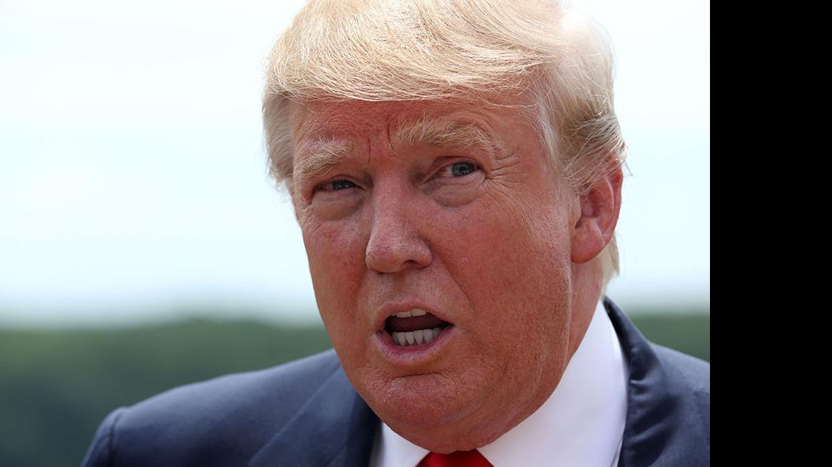 
Republican presidential hopeful Donald Trump talks to reporters during the grand opening of the Albemarle Estate at Trump Winery Tuesday outside Charlottesville, Va. 
