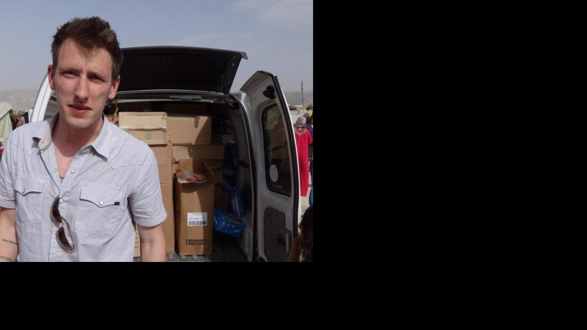 
(FILES) This Kassig Family released handout photo on October 4, 2014 shows Peter Kassig in front of a truck somewhere along the Syrian border between late 2012 and autumn 2013 as Special Emergency Response and Assistance (SERA) was delivering supplies to refugees before the American aid worker was held captive by Islamic State jihadists. The Islamic State jihadist group on November 16, 2014 claimed to have executed Peter Kassig as a warning to the United States, in video. 
