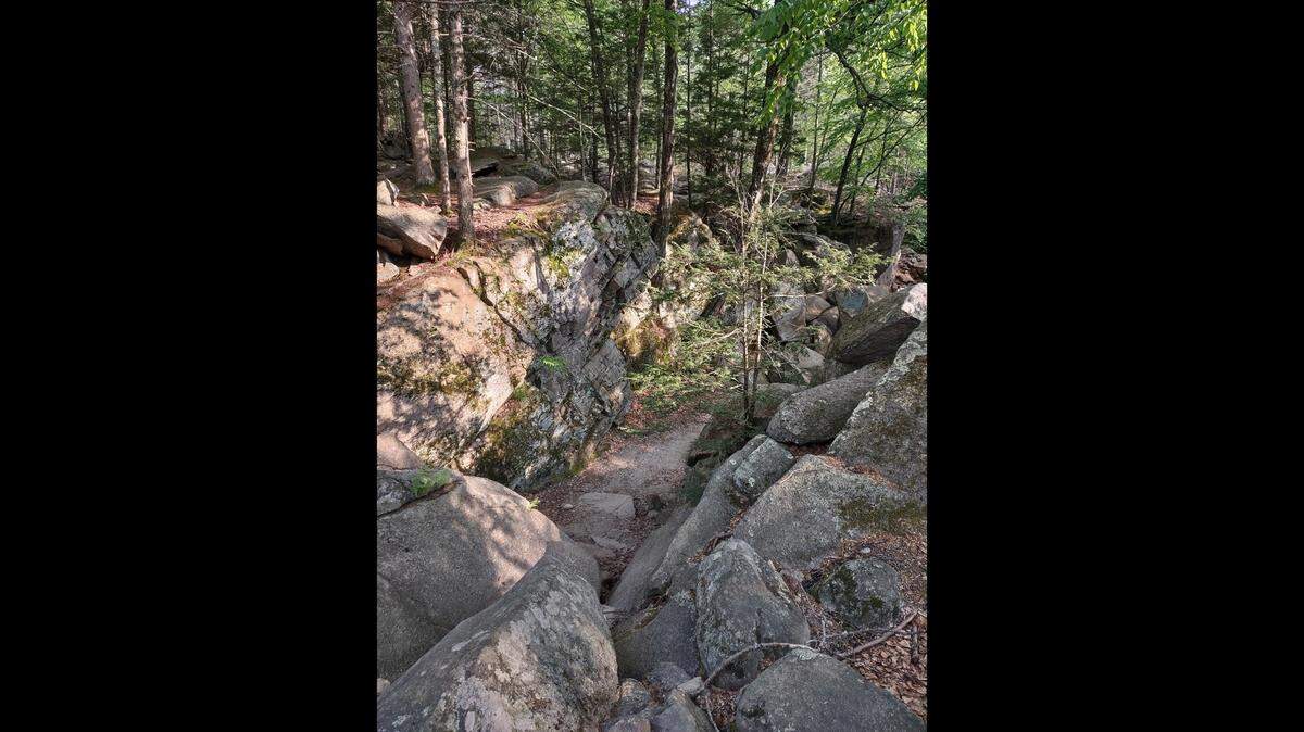 The Topsfield woman was hiking with three of her four children and other family members when she plunged into the chasm, police said.