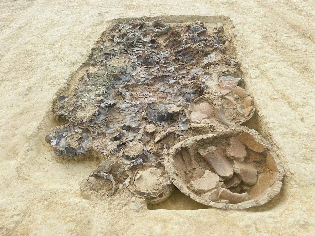 The rectangular pit, which is about 12 feet long, contains around 150 artifacts, officials said.
