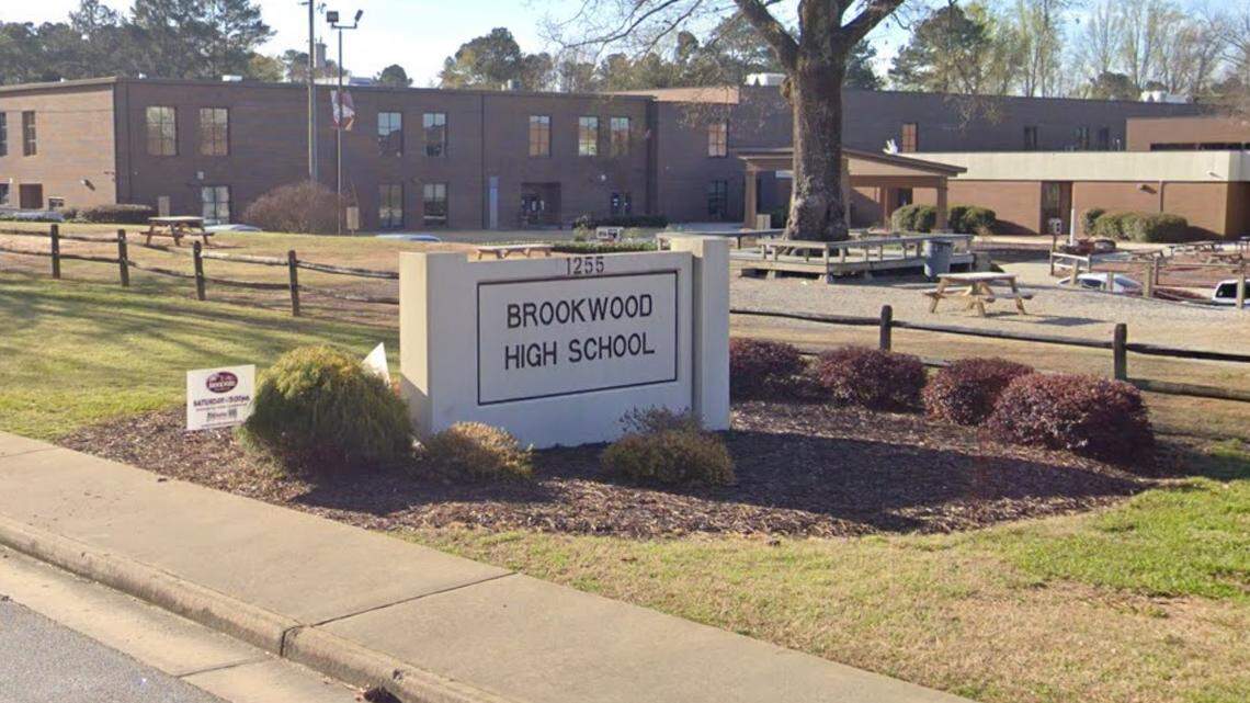 A student was charged after a classmate was found stabbed in a bathroom at Brookwood High School, a Georgia principal says