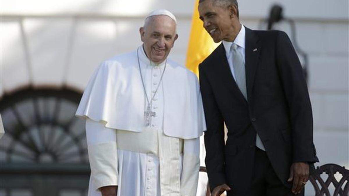 President Barack Obama leans over to talk to Pope Francis during a state arrival ceremony on the South Lawn of the White House in Washington, Wednesday, Sept. 23, 2015.