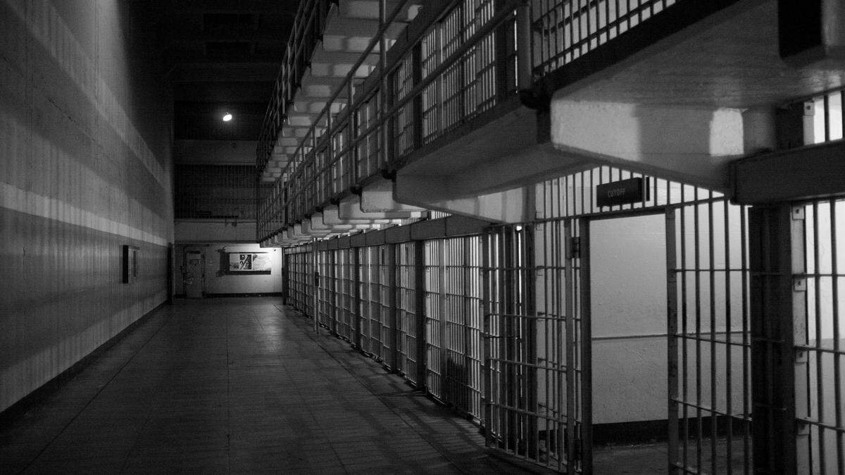 A prison officer performed sex acts on three inmates over a three-year period, officials say.