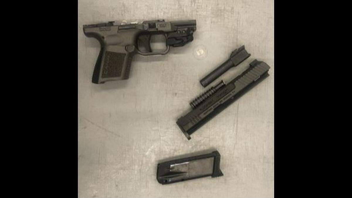 A man is charged after he was caught with gun parts at a security checkpoint at Newark Liberty Airport, TSA officials said.