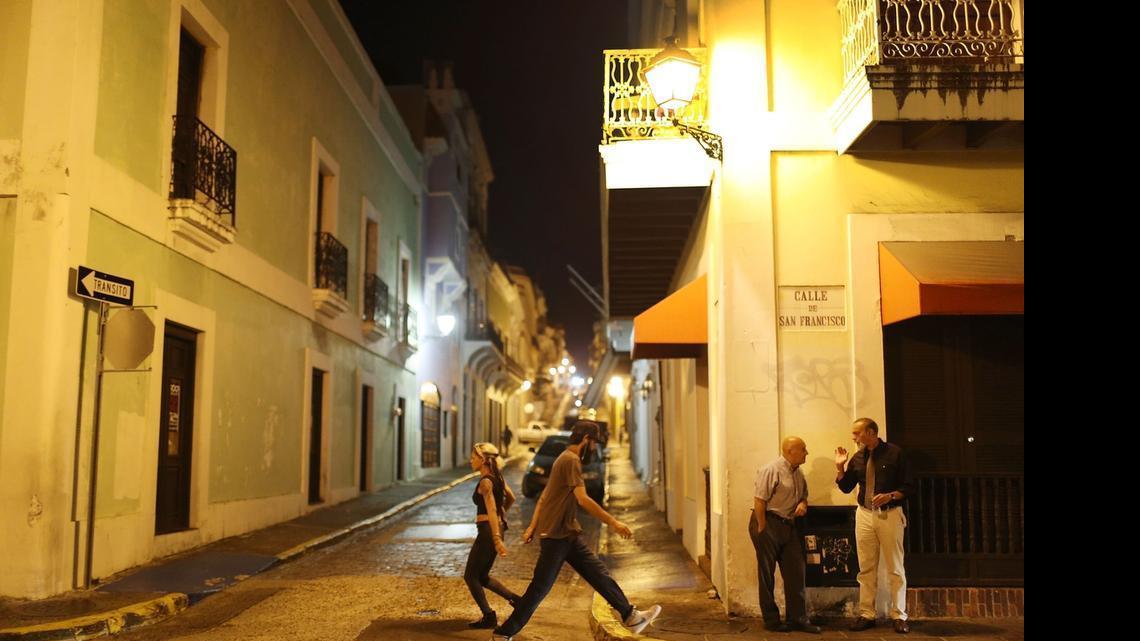 
People walk through the streets after Puerto Rican Governor Alejandro Garcia Padilla gave a speech regarding the government's $72 billion debt on June 29, 2015 in San Juan, Puerto Rico. The Governor said in his speech that the people will have to sacrifice and share in the responsibilities for pulling the island out of debt. 
