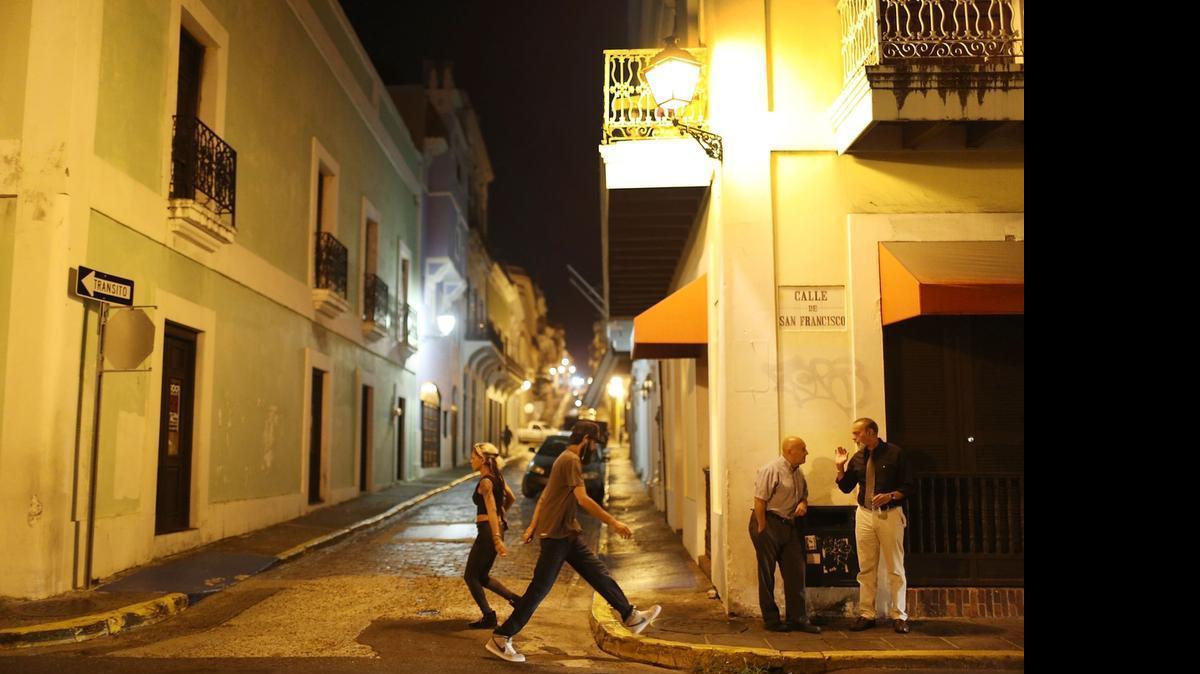 
People walk through the streets after Puerto Rican Governor Alejandro Garcia Padilla gave a speech regarding the government's $72 billion debt on June 29, 2015 in San Juan, Puerto Rico. The Governor said in his speech that the people will have to sacrifice and share in the responsibilities for pulling the island out of debt. 

