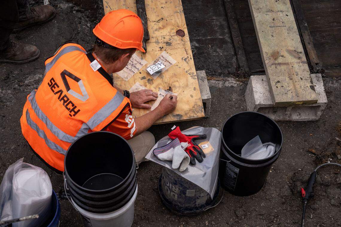 SEARCH archaeologist Greg Hendryx bags artificacts as the hull is excavated. “Every find, including artifacts such as broken bottles, shoes and wood fragments from the vessel, were mapped, cataloged and bagged with water for further laboratory analysis by SEARCH archaeologists,” officials said of the excavation.