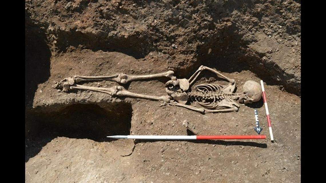 The teenage girl was buried face down with her ankles bound in Conington, England.