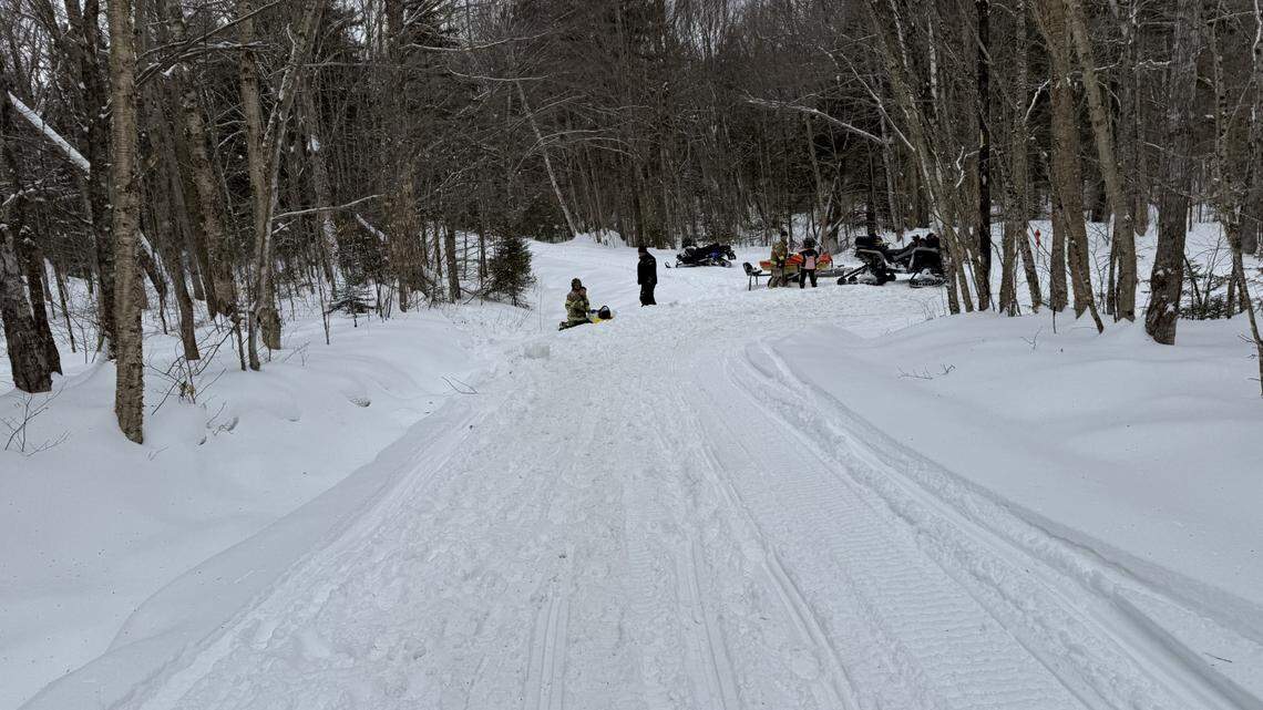 Rescuers rushed to help an injured snowmobiler after he crashed into a tree.