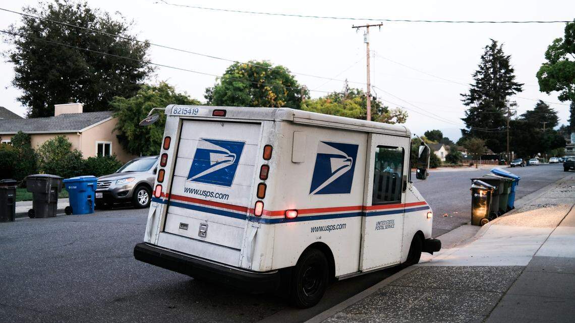 A postal worker was attacked by two dogs when she was delivering a package to a home for the first time, Georgia deputies said.