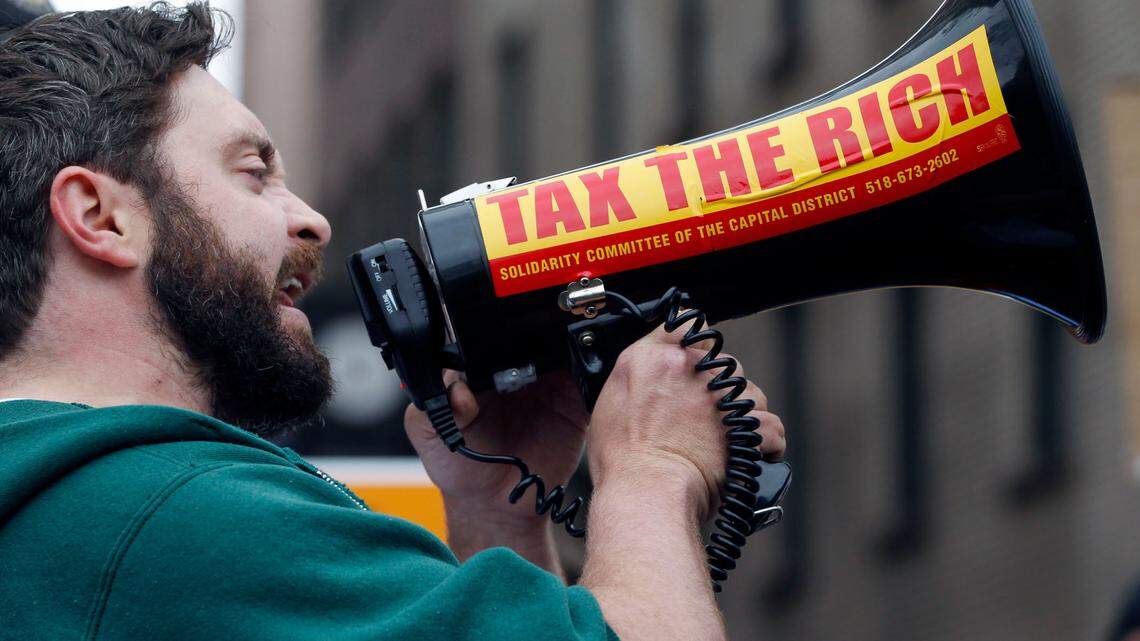 A majority of Americans across partisan and racial lines support raising taxes on the wealthy and large corporations, according to a new poll. (AP Photo/Mike Groll)