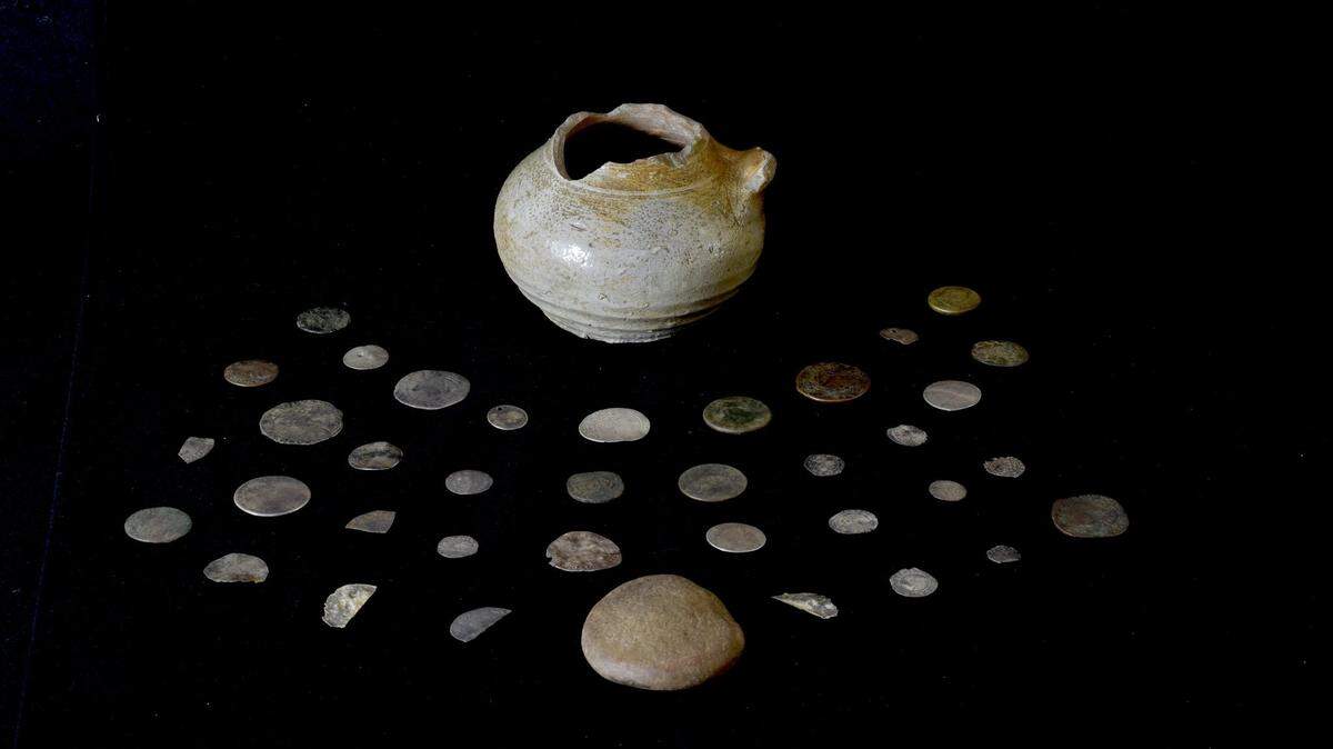 A hoard of coins dating back at least 300 years was uncovered underneath a fireplace in Scotland, according to university officials. It may be connected to an infamous 1692 massacre.