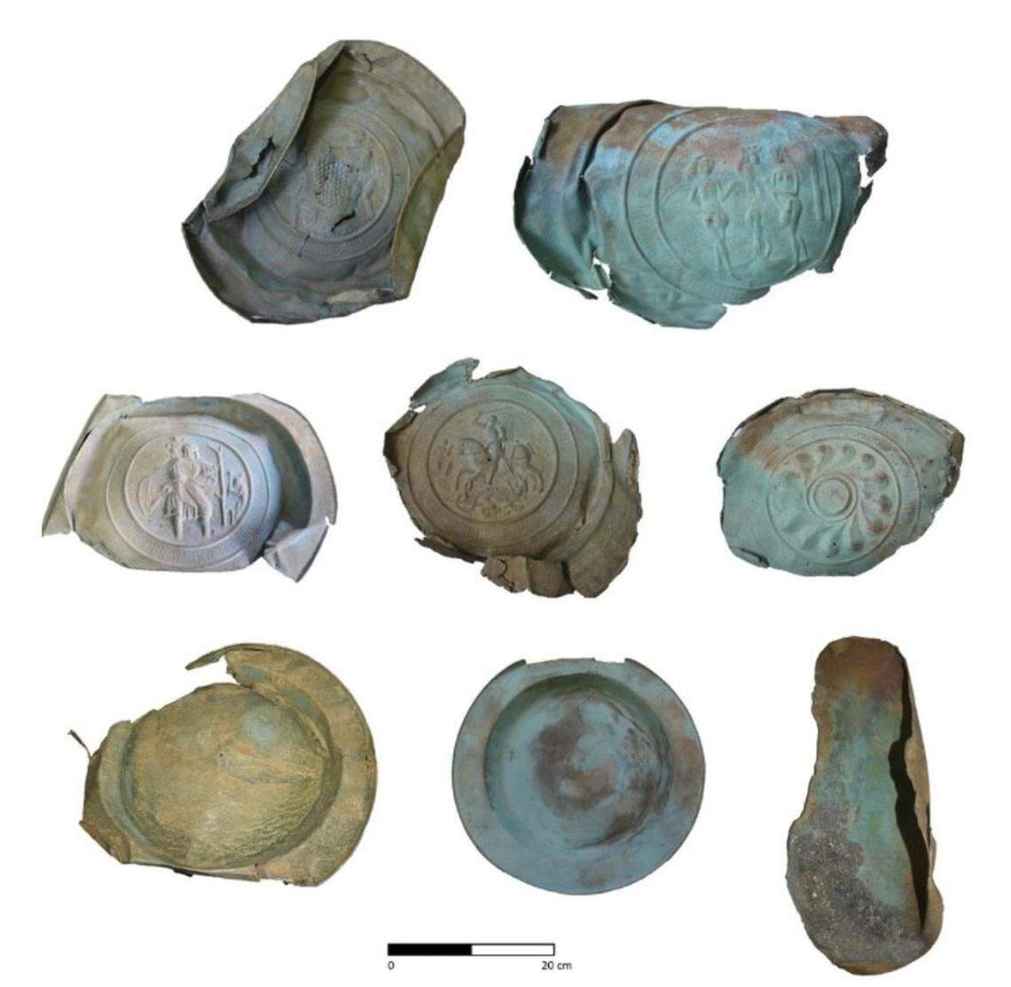 The recovered alms dishes are decorated with various motifs, including a dragon and a baby Jesus.