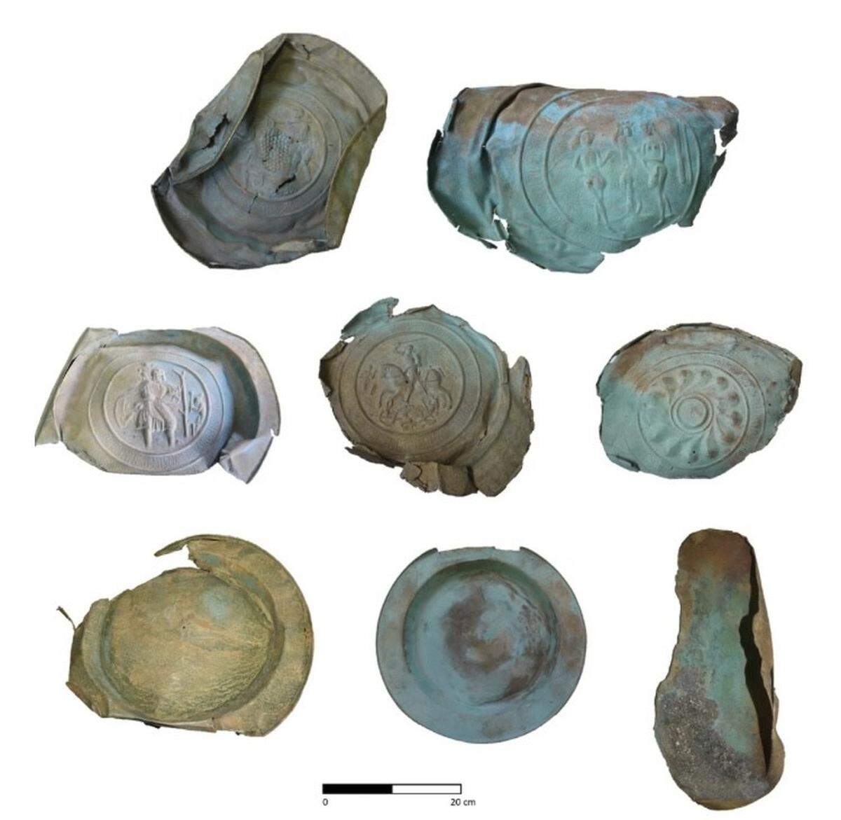 The recovered alms dishes are decorated with various motifs, including a dragon and a baby Jesus.