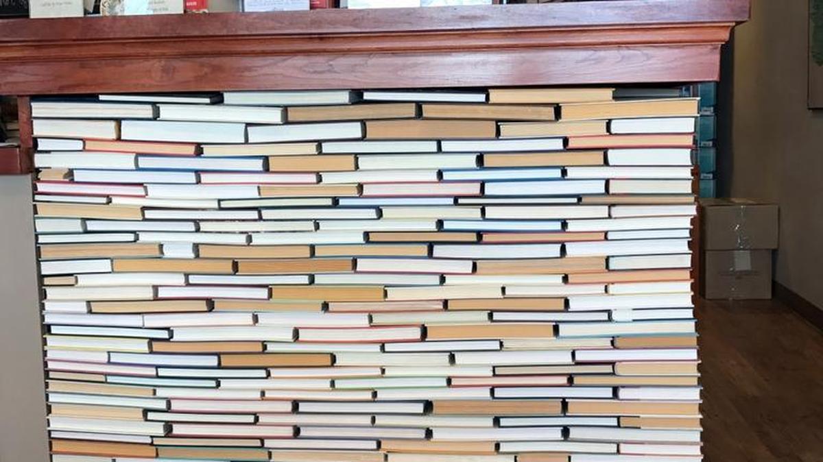 This undated photo shows the check-out counter at the indie bookseller Newtonville Books in Newton, Mass. The counter is made of rows of backward books glued into place.