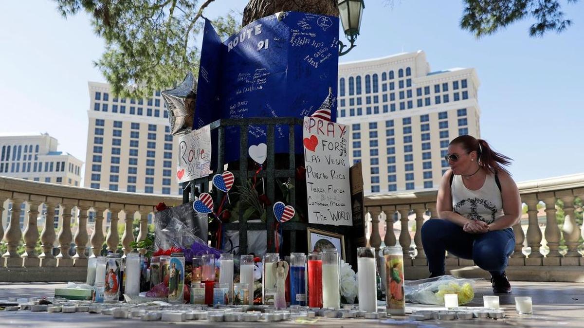 Allison Easterbrooks pauses at a memorial for the people killed in Sunday's mass shooting on Wednesday, Oct. 4, 2017, in Las Vegas. Stephen Paddock opened fire on an outdoor country music festival on Sunday killing dozens and injuring hundreds.