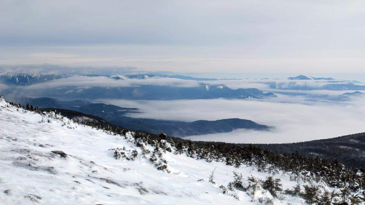 The hikers were caught waist-deep in snow on Mount Moosilauke, New Hampshire rescuers say.