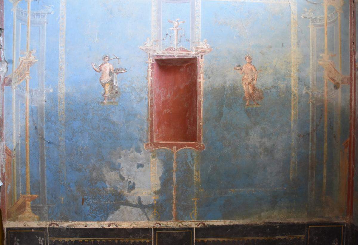 Two female figures painted on one of the shrine walls