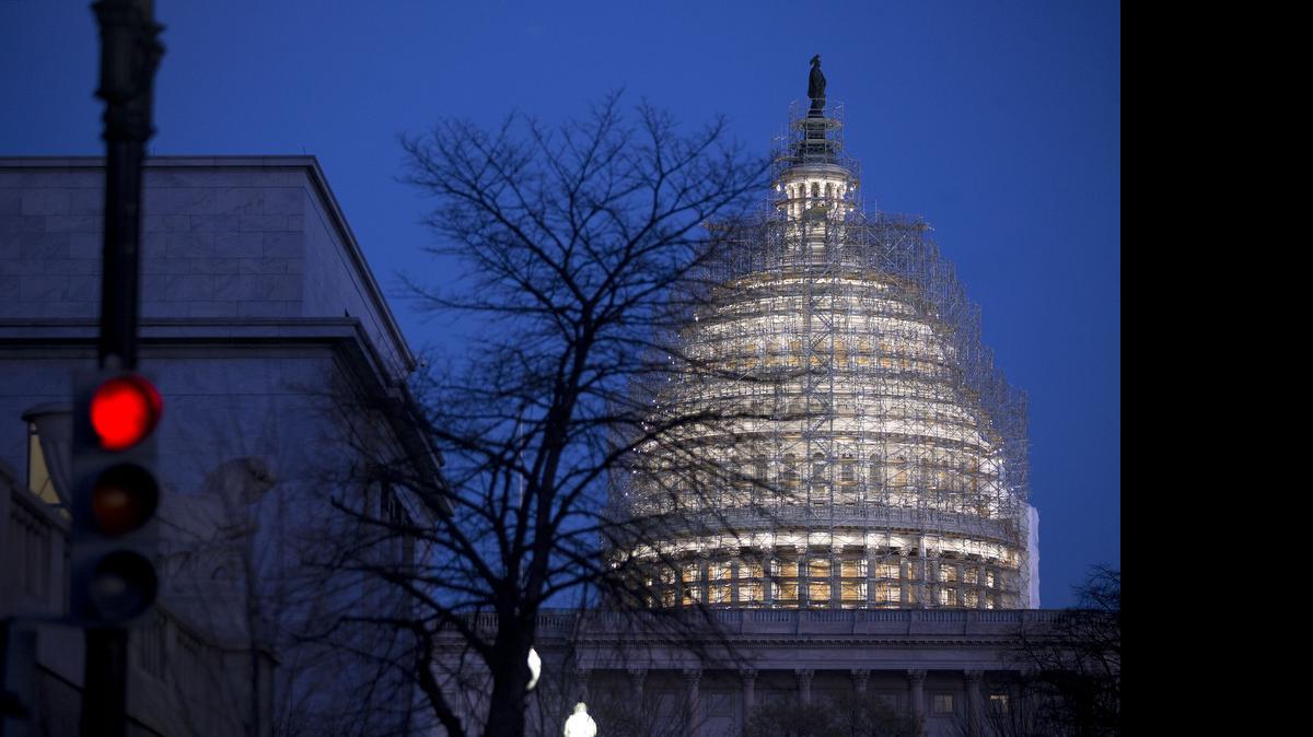 
Scaffolding surrounds the U.S. Capitol Building Dome before sunrise in Washington, D.C., U.S., on Wednesday, Dec. 10, 2014.
