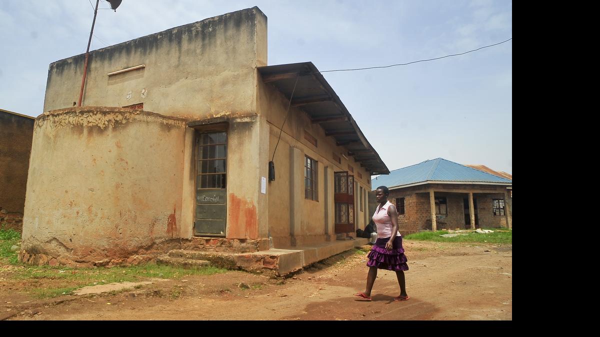 
In this photo taken Tuesday, April 14, 2015, a woman walks past the Masjid Taqwa mosque in the Zana suburb of Kampala, Uganda. A crackdown by Ugandan police on suspected Islamic extremists has sent a current of fear through the Islamic community in Uganda, especially in the Masjid Taqwa mosque whose imam, former Guantánamo Bay prisoner Jamal Kiyemba, was recently arrested. 
