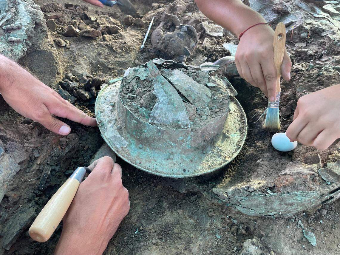 A number of ornately decorated bronze objects were recovered, including a cauldron and a helmet, officials said.