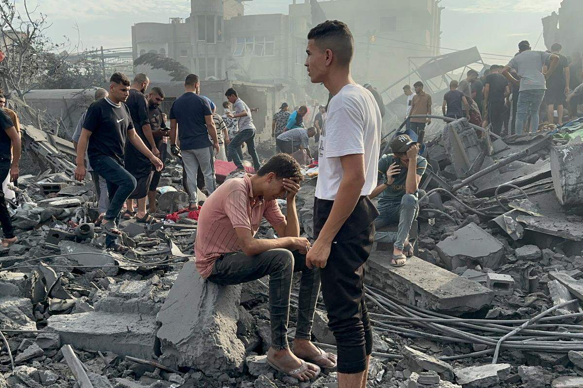 Palestinians look for survivors following Israeli airstrike in Nusseirat refugee camp, Gaza Strip, Tuesday, Oct. 31, 2023. (AP Photo/Doaa AlBaz)