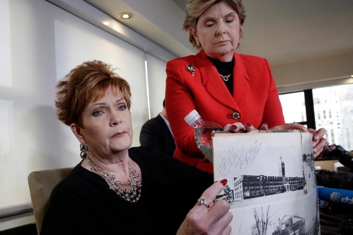 Beverly Young Nelson, left, the latest accuser of Alabama Republican U.S. Senate candidate Roy Moore, and attorney Gloria Allred hold Nelson's high school yearbook, signed by Moore, at a news conference, in New York, Monday, Nov. 13, 2017. Nelson says Moore assaulted her when she was 16 and he offered her a ride home from a restaurant where she worked. Moore says the latest allegations against him are a “witch hunt.”