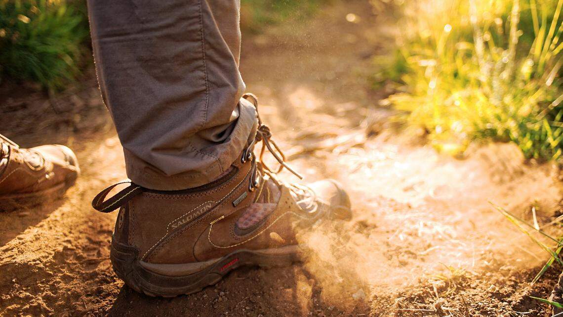 When the group encountered the unconscious man on the trail, they called for help. Then, they carried him to safety.