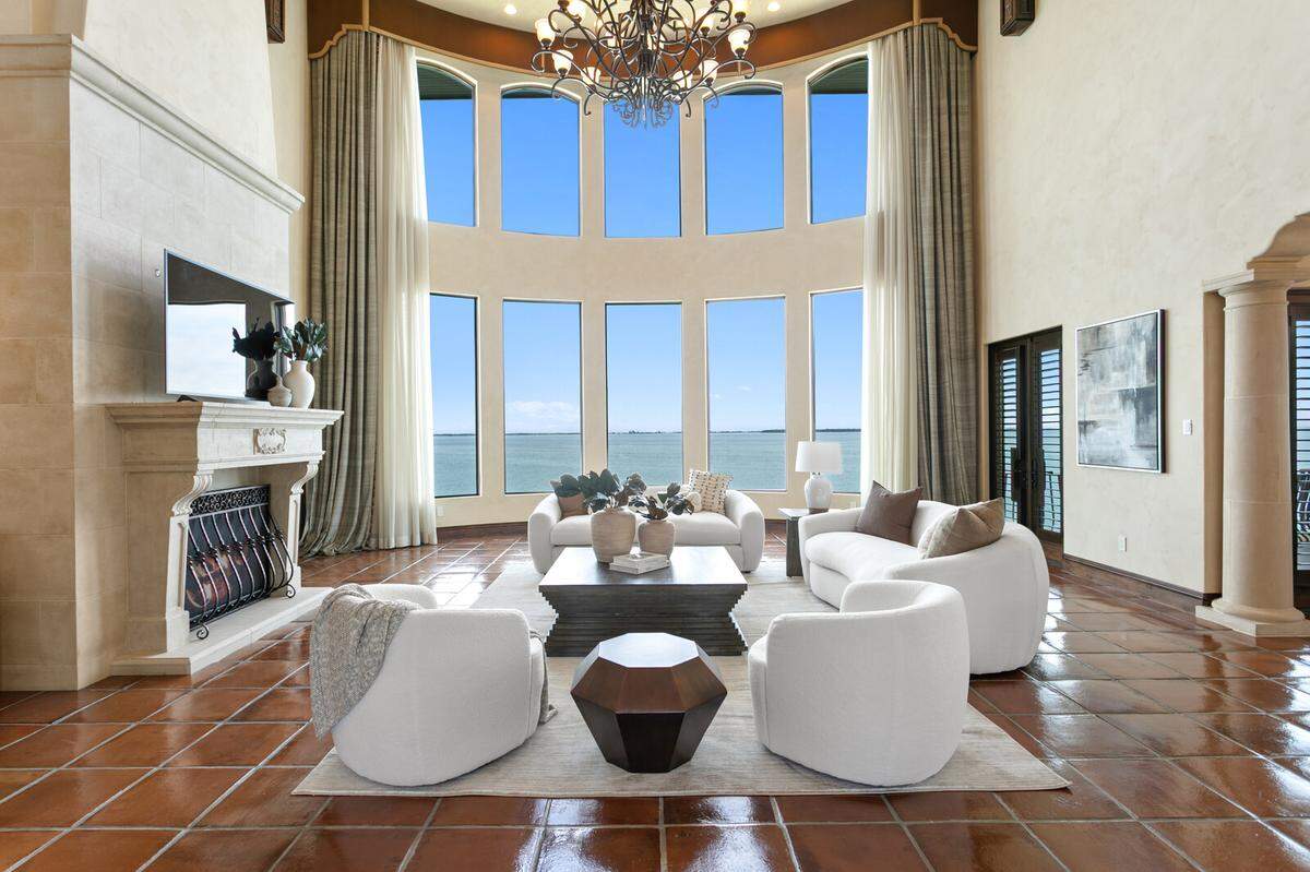 There are five bedrooms in the house, as well as this dramatic great room, featuring soaring 2-story ceilings, Saltillo tile flooring and breathtaking views.