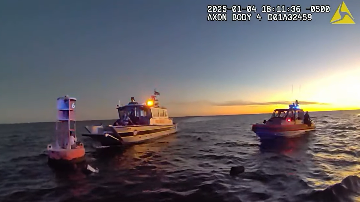 Two people and a dog were rescued from a buoy in the Tampa Bay after a boating accident, authorities said.