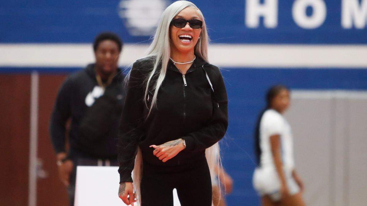 Rapper GloRilla laughs after taking part in a shooting contest at halftime during the game between Bartlett High School and Sierra Canyon School in the 901 Tournament of Champions at Bartlett High School on Friday, December 22, 2023.