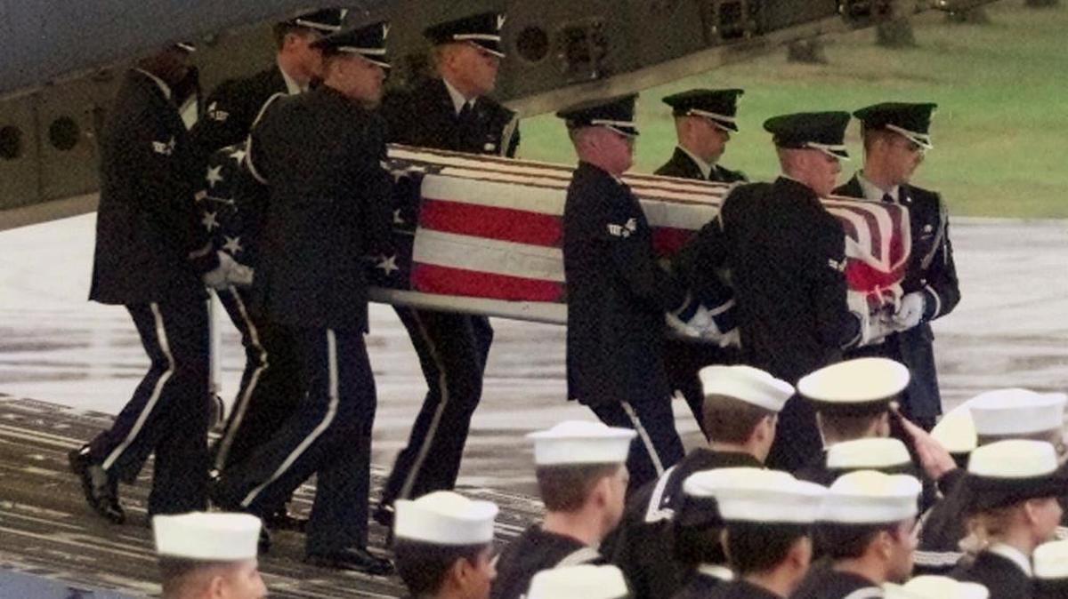 A U.S. Air Force honor guard carries the coffin of a sailor from a C-17 Air Force aircraft at the U.S. air base in Ramstein, Germany, Friday, Oct. 13, 2000. Seventeen sailors died and 33 were injured in the bombing of the USS Cole while it was refueling in the Yemeni port of Aden.