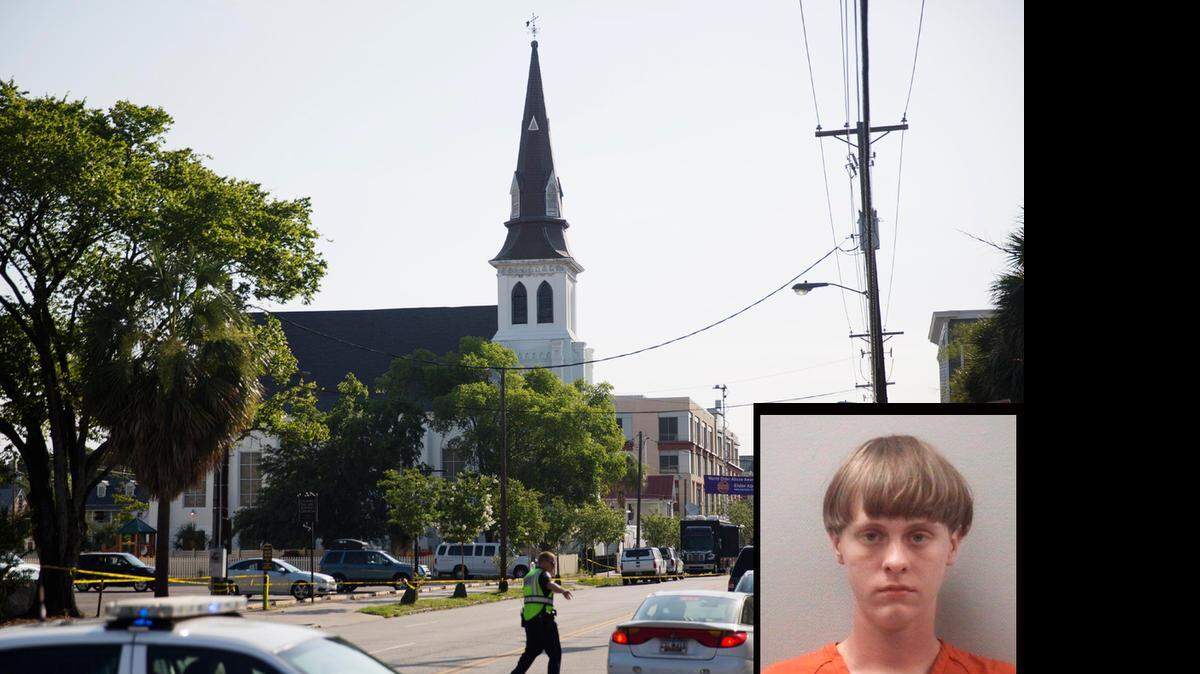 The steeple of Emanuel AME Church rises above the street as a police officer tells a car to move as the area is closed off following Wednesday's shooting, Thursday, June 18, 2015 in Charleston, S.C. Police identified the shooter who opened fire during a prayer meeting inside the church as Dylann Roof, 21.