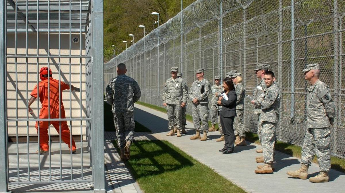 Debra S. Wada, assistant secretary of the Army FOR Manpower and Reserve Affairs, Maj. Gen. Mark S. Inch, U.S. Army provost marshal general, and Col. Zane H. Jones, commander, 18th Military Police Brigade, observe a forced cell extraction demonstration during a visit to the correctional facility at Sembach Kaserne, Kaiserslautern, Germany, April 23, 2015.