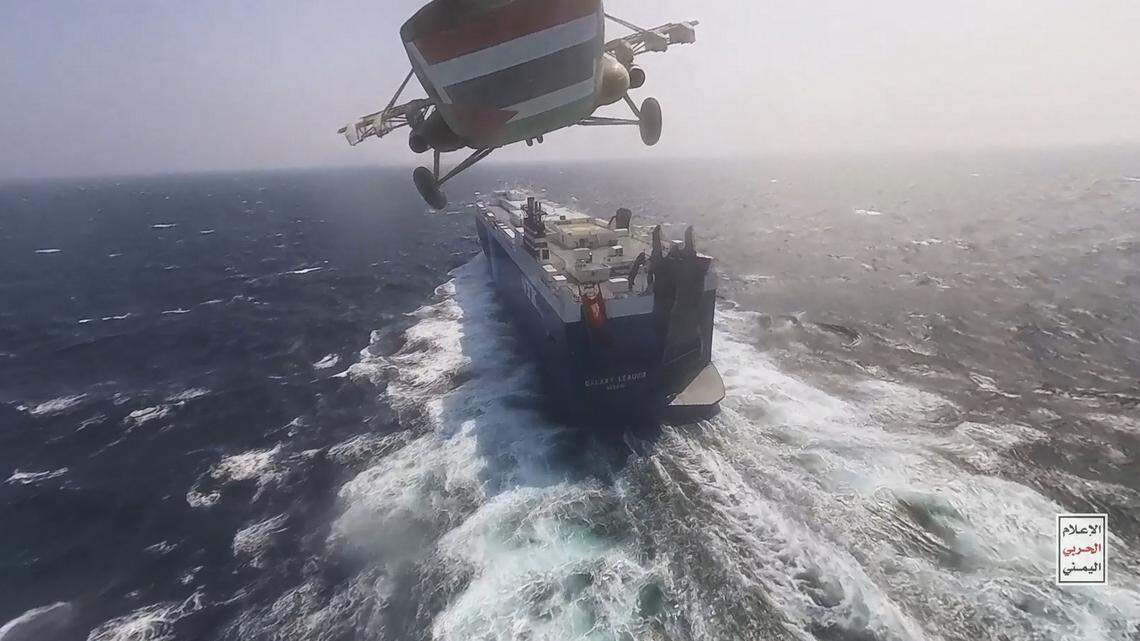 This photo released by the Houthi Media Center shows a Houthi forces helicopter approaching the cargo ship Galaxy Leader on Sunday, Nov. 19, 2023. (Houthi Media Center via AP)