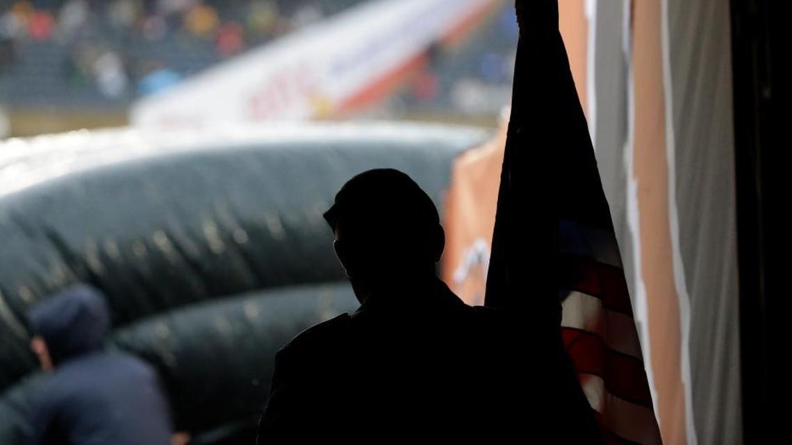 A U.S. Army command sergeant waits in the tunnel before an NFL football game on Sunday.