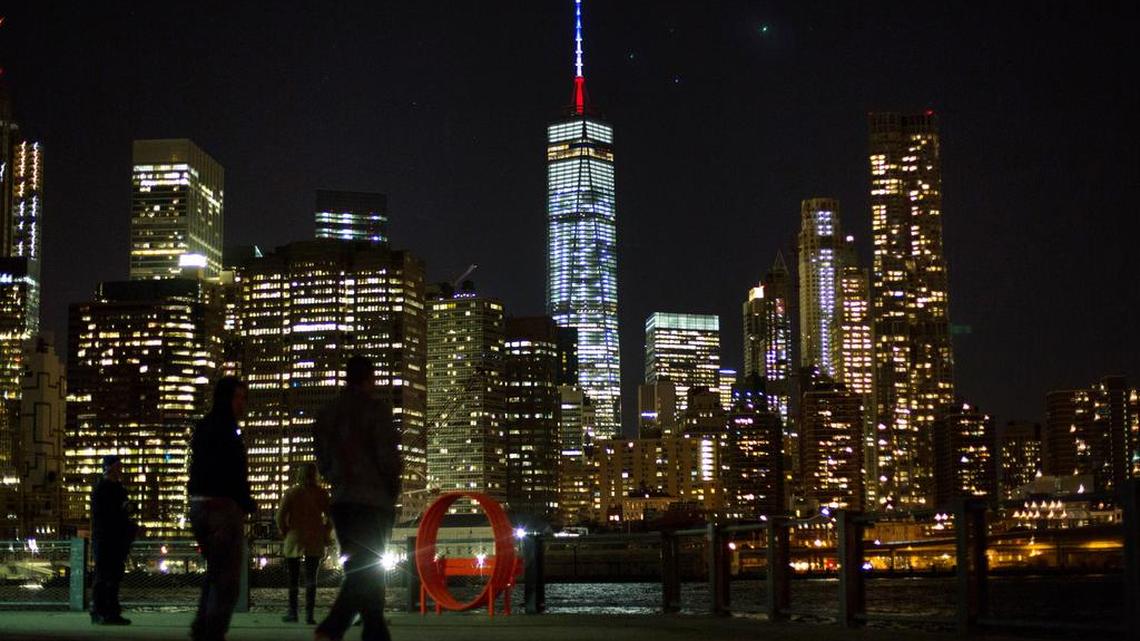 One World Trade Center's spire lit in blue, white and red on Friday, Nov. 12, 2015 after terror attacks in Paris, France.